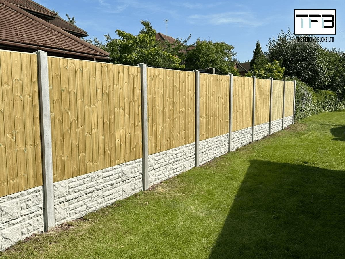 A line of T&G garden fencing with concrete posts and rock-faced concrete gravel boards.